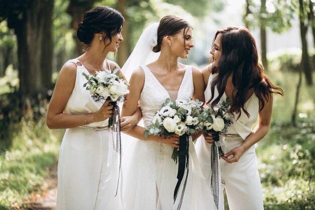 Bride with her bridesmaids in forest