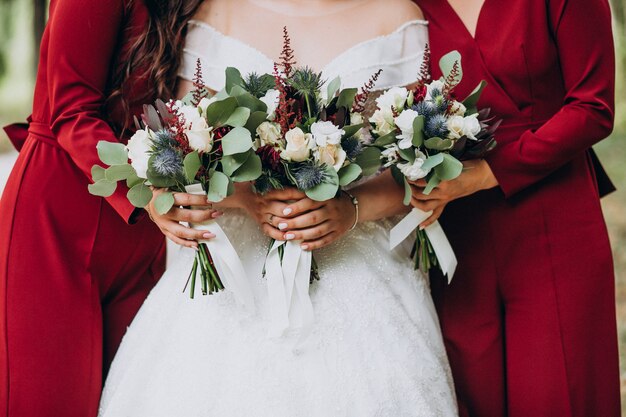 Bride with wedding bouquet in the middle of bridesmaids