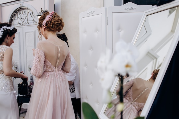 The bridesmaid stands in the room