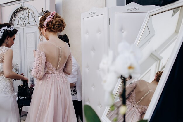 The bridesmaid stands in the room