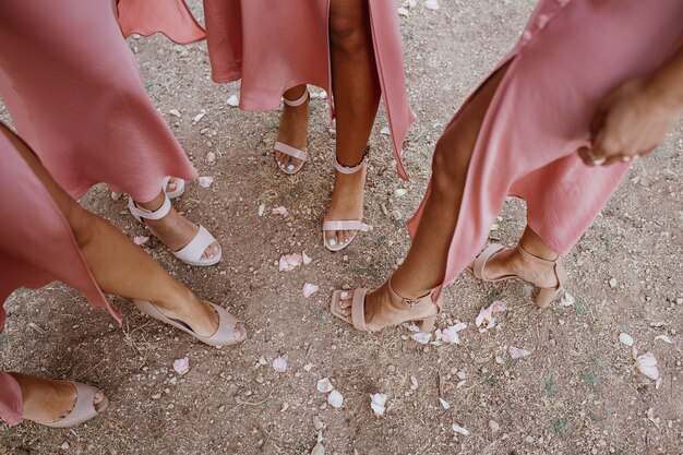 Bridesmaids in pretty dresses celebrating the wedding outdoors