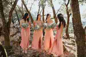 Free photo bridesmaids in pretty dresses outdoors