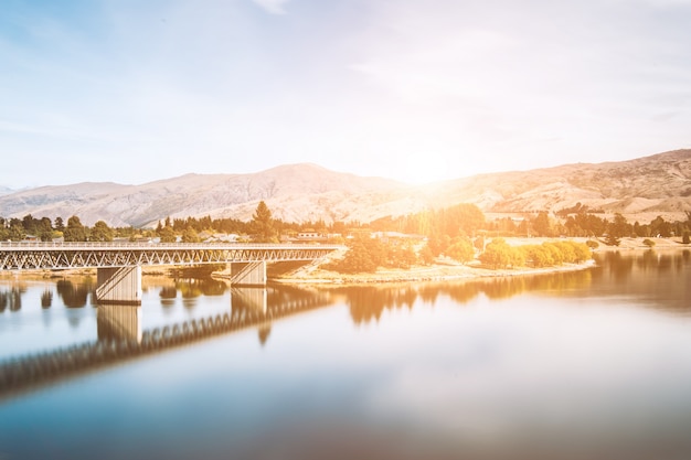 Bridge crossing a lake at sunset – Free Downloadable Stock Photo