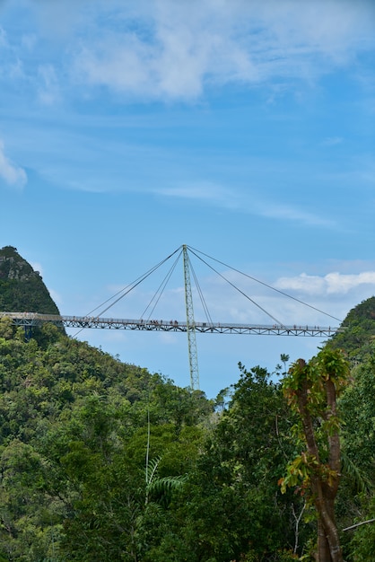 Bridge crossing between two mountains with trees