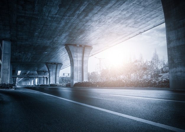 Under a bridge at sunset