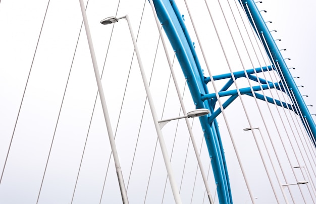 Free photo bridge with lampposts and blue arch