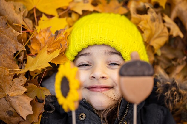 Bright autumn gingerbread in the hands of a child