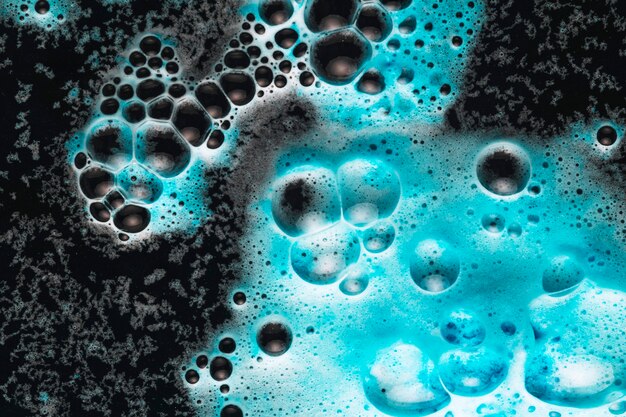 Bright blue foam on dark water