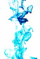 Free photo bright blue ink drop on white