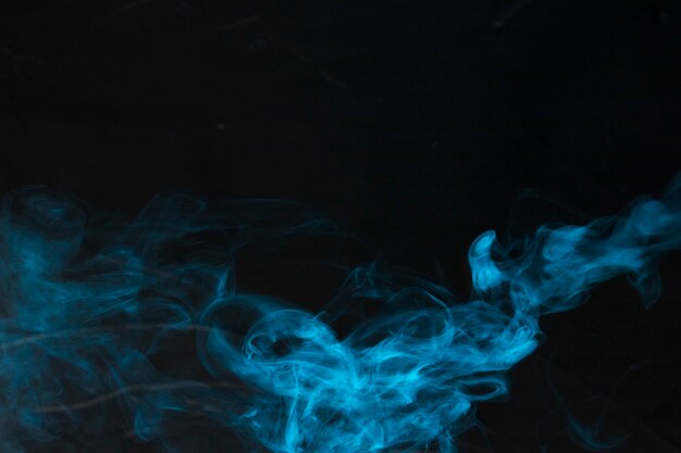 Bright blue smoke cloud over a dark background