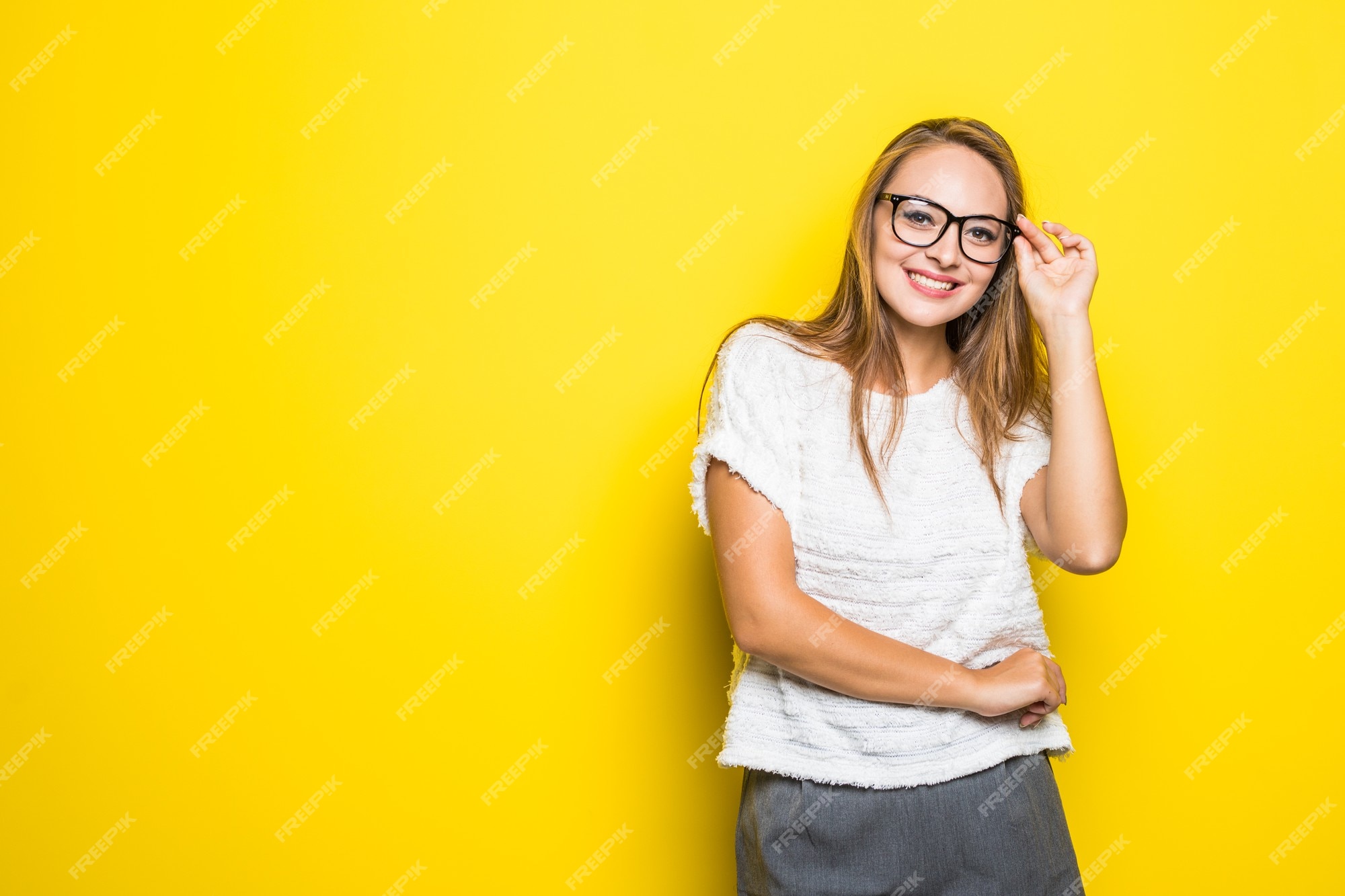 Smiling Brunette Woman Wearing a Yellow Sweater, and Playing