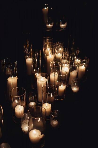 Bright candles burn standing on the floor