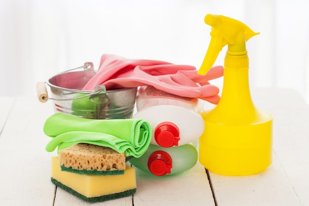 Bright colorful cleaning set on a wooden table