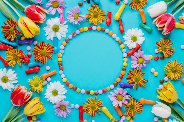 Bright composition of flowers and candies