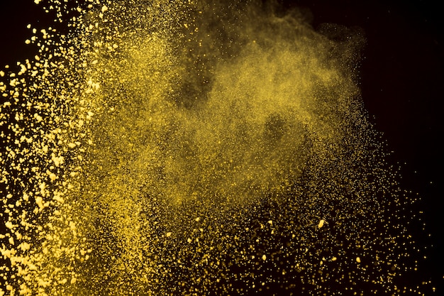 Bright dust of makeup powder on dark background