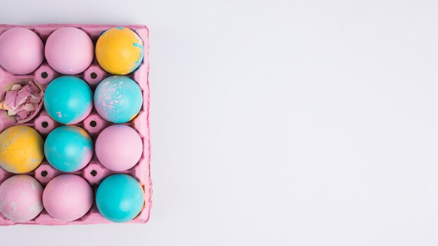 Bright Easter eggs in pink container