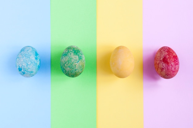 Bright eggs on colorful background