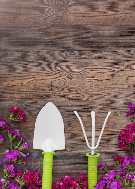 Bright flowers near gardening tools