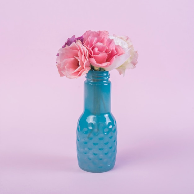 Bright flowers in vase on table 