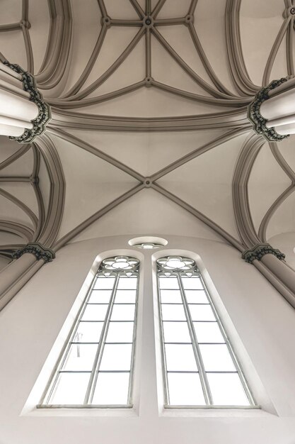 Bright interior of the church with stainedglass windows view from below