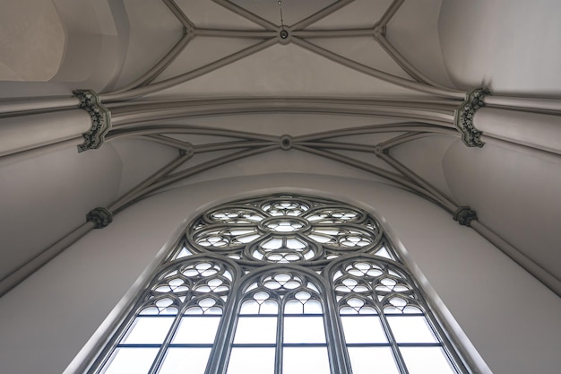아래에서 스테인드글라스 창문이 보이는 밝은 교회 내부
