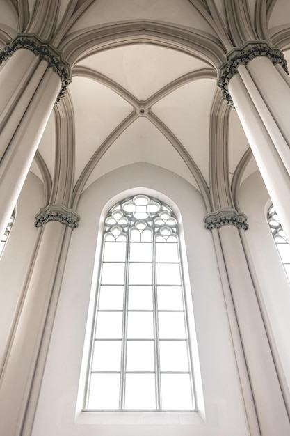 Free photo bright interior of the church with stainedglass windows view from below