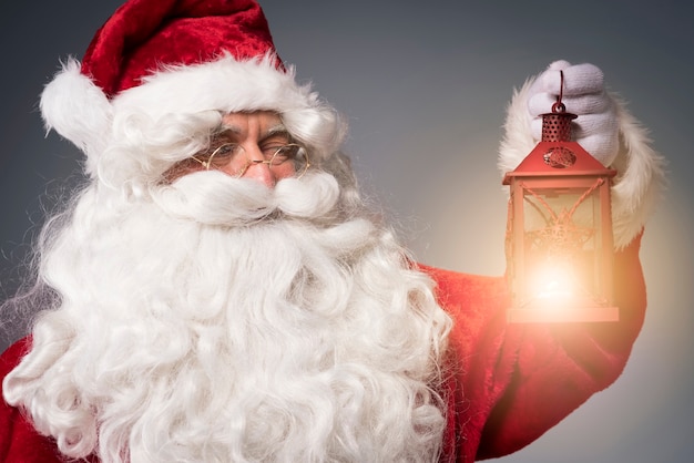 Free photo bright lantern held by the santa claus