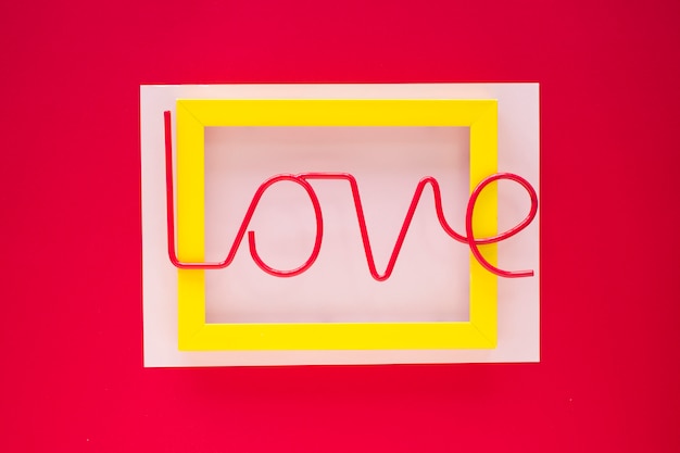 Free photo bright love inscription on yellow frame