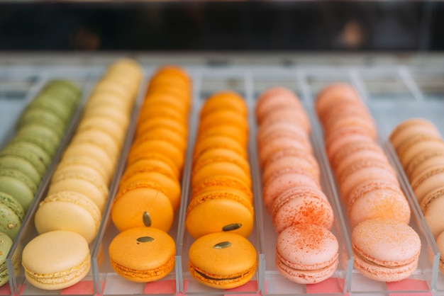 Bright macaroons on display case in cafe