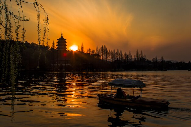 Bright mesmerizing sun setting over the West Lake, Hangzhou, China