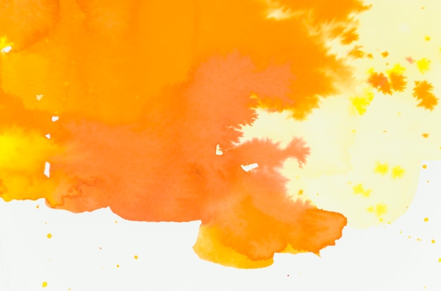 Bright mixed orange and yellow watercolor shade on white backdrop