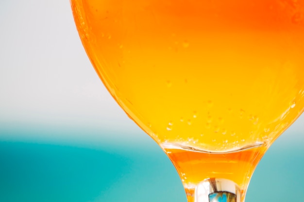 Bright orange fresh drink in round glass