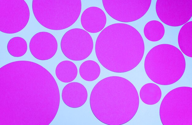 Bright pattern of pink circles on blue background