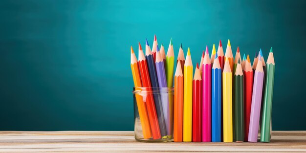 Bright pencils and books for a creative day next to a green board back to school