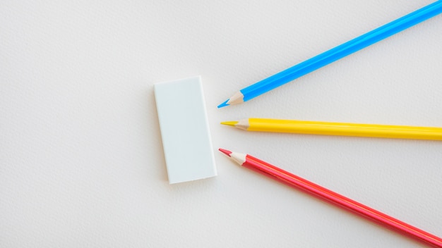 Bright pencils lying near rubber