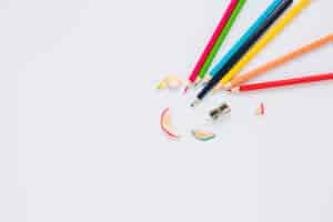 Free photo bright pencils near sharpener and shaving