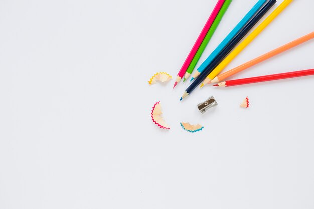 Bright pencils near sharpener and shaving