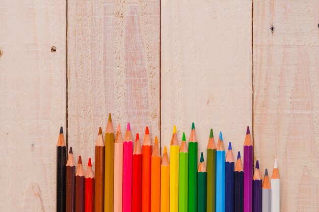 Bright pencils on wood