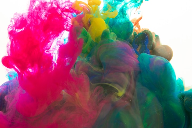 Free photo bright pigments mixing in water