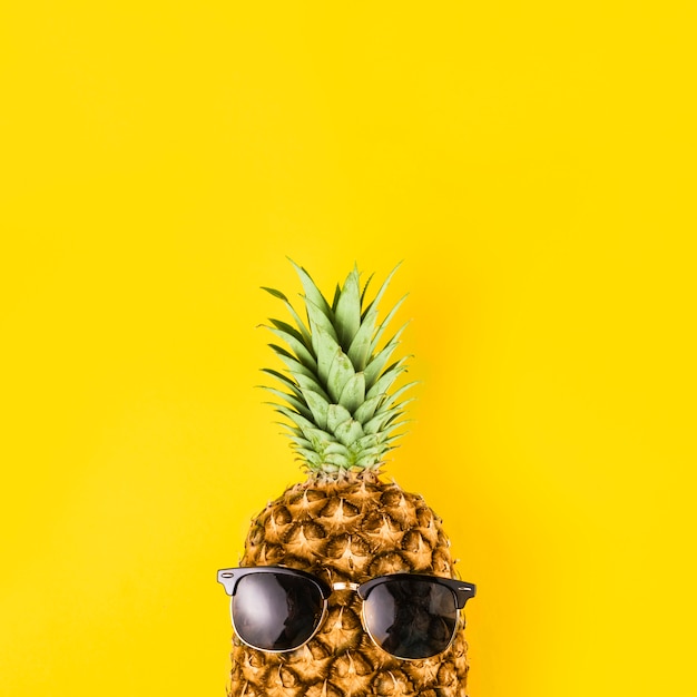 Bright pineapple in sunglasses