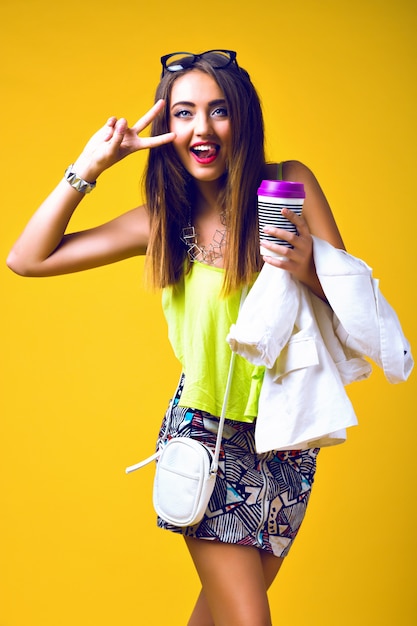 Bright positive fashion portrait of pretty young woman, stylish trendy neon outfit, smart casual, cute emotions, color pop