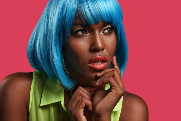 Bright pportrait of a black woman wearing blue wig