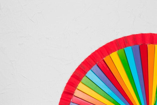 Bright rainbow fan on white surface