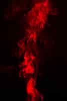 Free photo bright red smoke on dark background