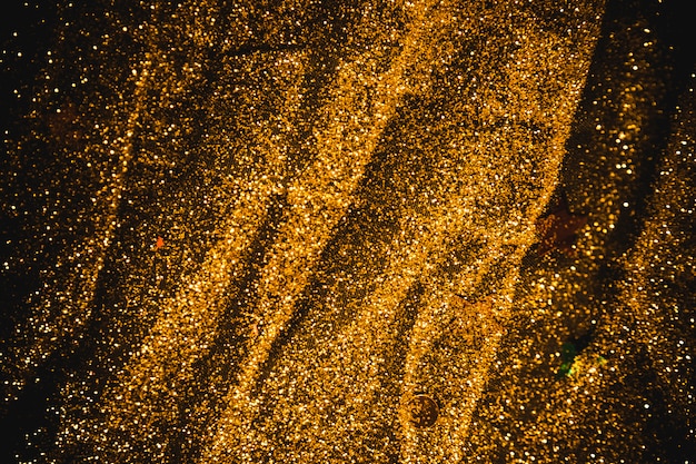 Free photo bright sequins scattered on black table