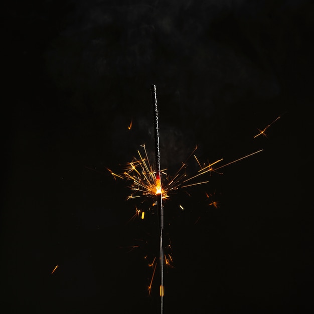 Bright sparkler on dark background