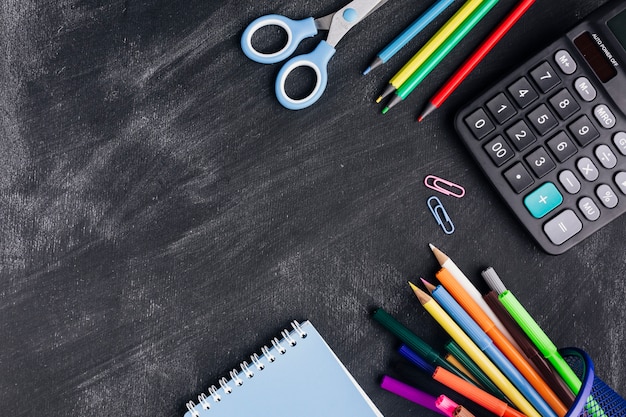 Free photo bright stationery and calculator on grey background