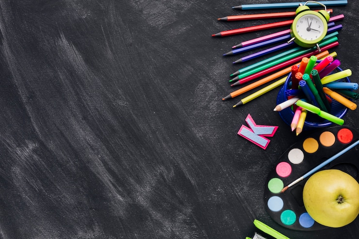 Free Photo bright stationery, clock and apple on dark background