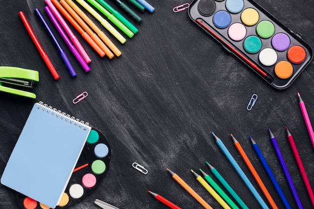 Free photo bright stationery for creating art on dark background