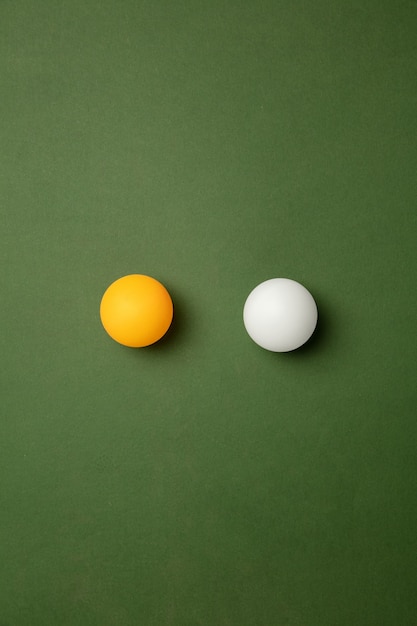 Bright table tennis, ping pong balls. Professional sport equipment isolated on green background.